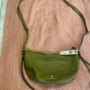 Green Michael Kors small purse with adjustable shoulder straps. Brand New.